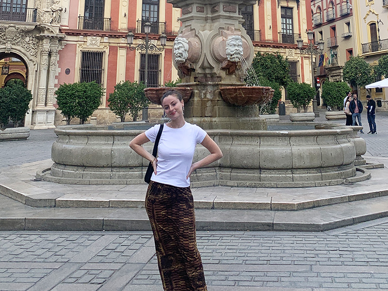 Ilah Saltzman in front of a fountain in a square