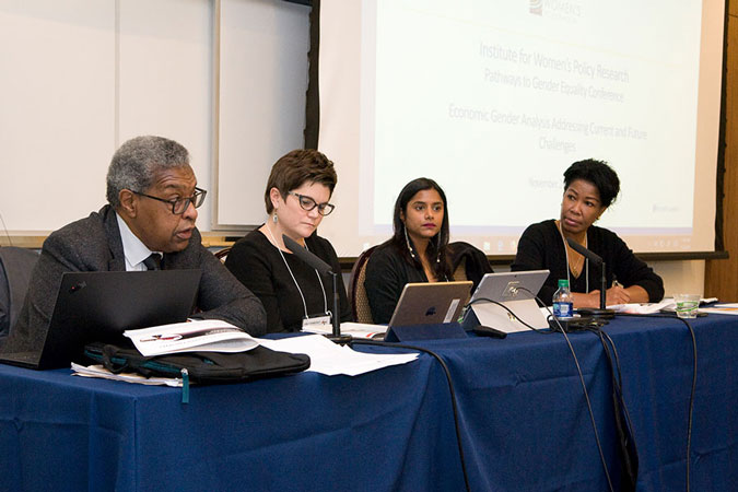 Panelists in front of a screen