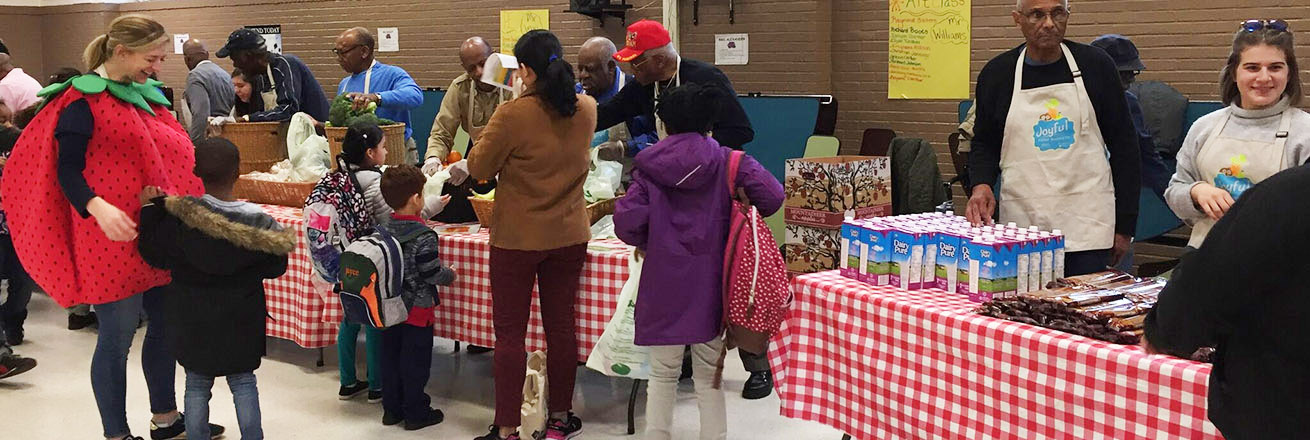 Dr. Snelling and children at a food fair