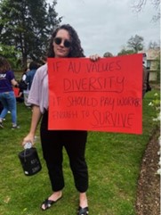 Carmen Bolt with sign reading "If AU values diversity, it should pay workers enough to survivie"