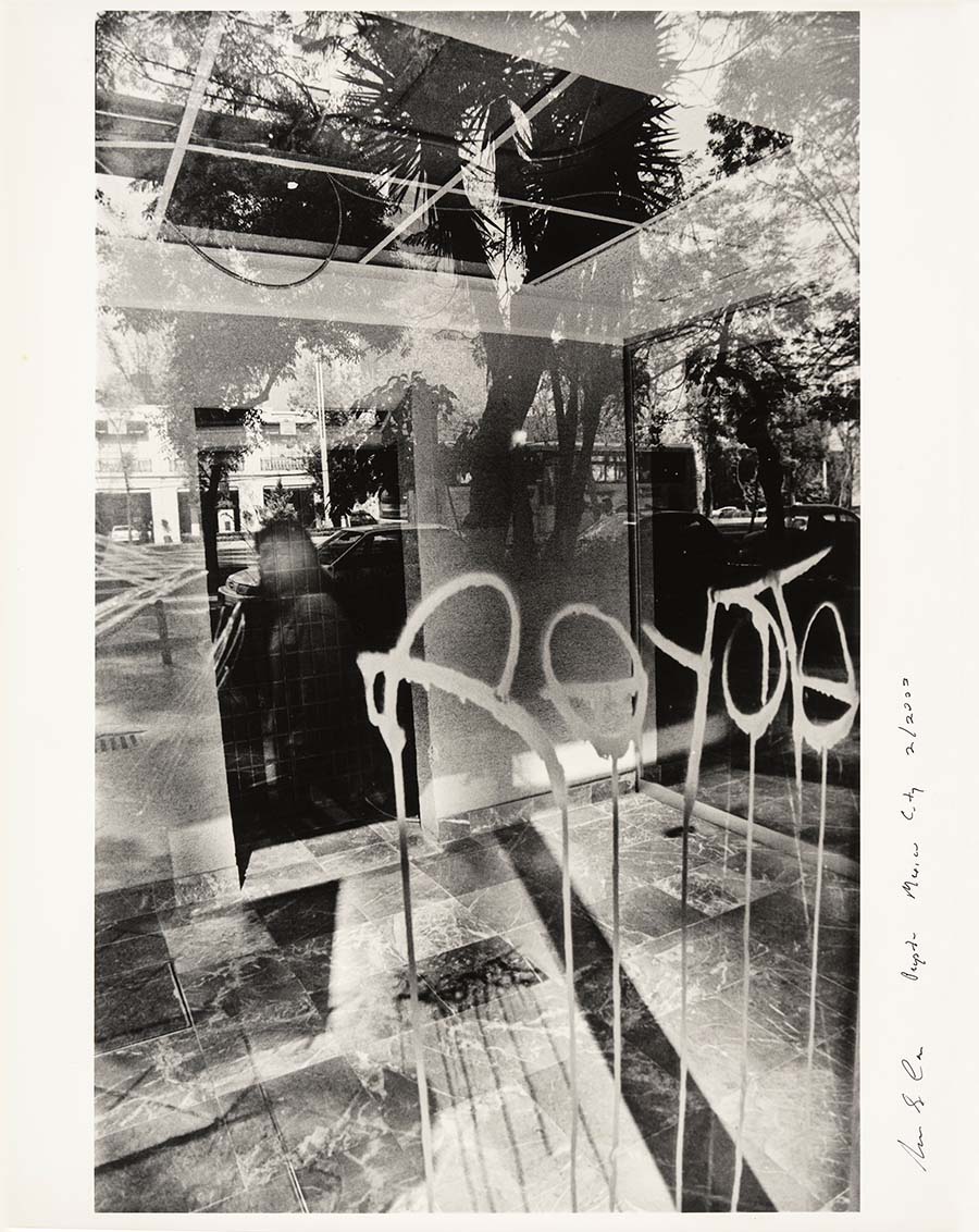 Norman S. Carr, Peyote—Mexico City, 2003. Interior shot of building with window reflection and grafitti.