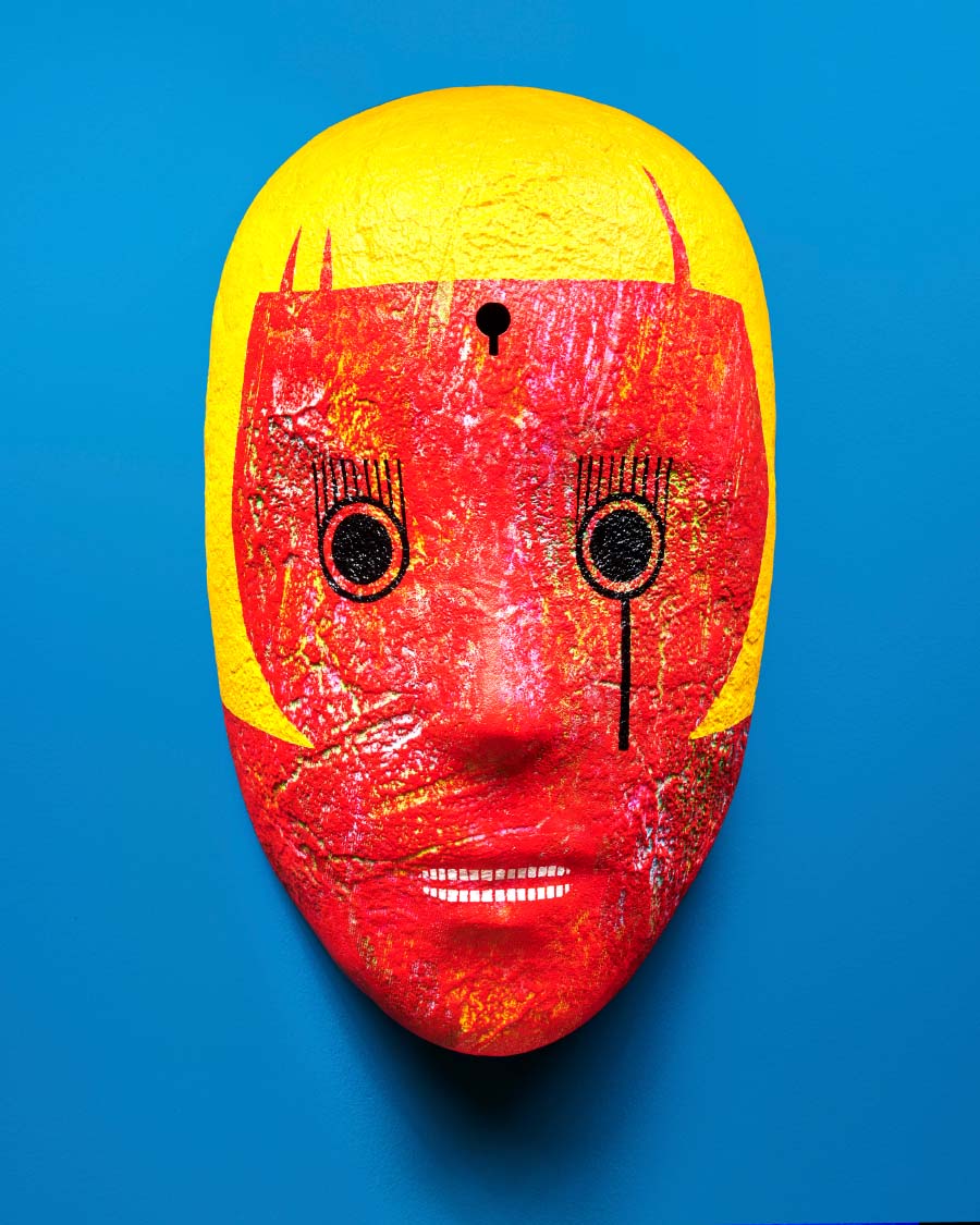 Ahn Chang-Hong, Mask, 2018. Red mask with black eyes, white teeth, and yellow bangs on a blue background. 