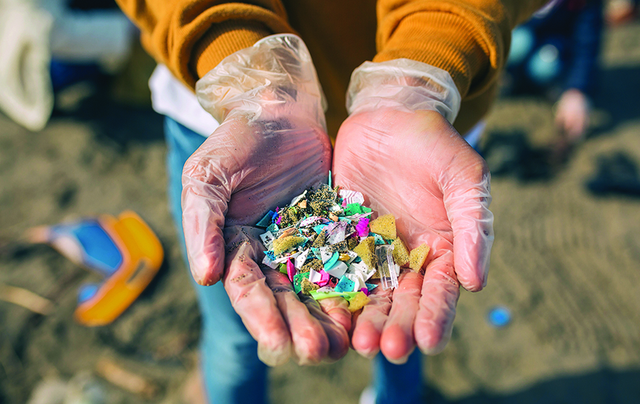 Hands holding microplastics