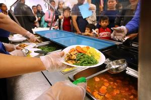 Students line up to be served lunch at cafeteria
