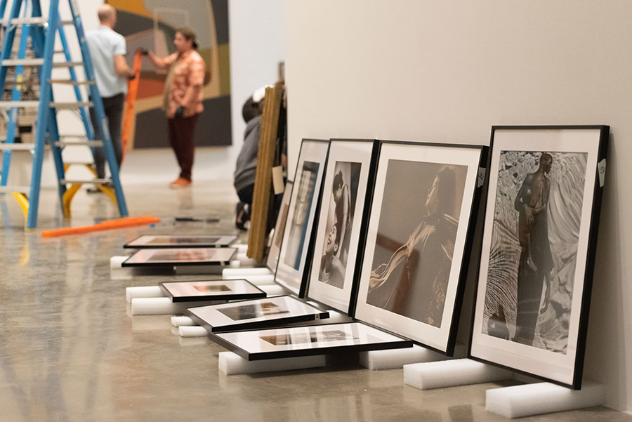 Artwork sits on foam panels on the floor before it is hung up on the museum walls