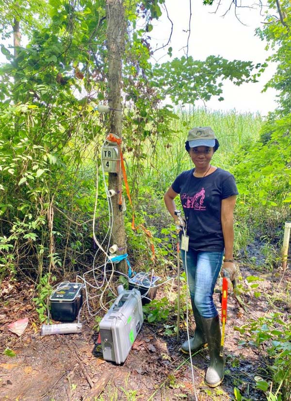 Glory Iorliam ’24 in the field measuring gas emissions from trees