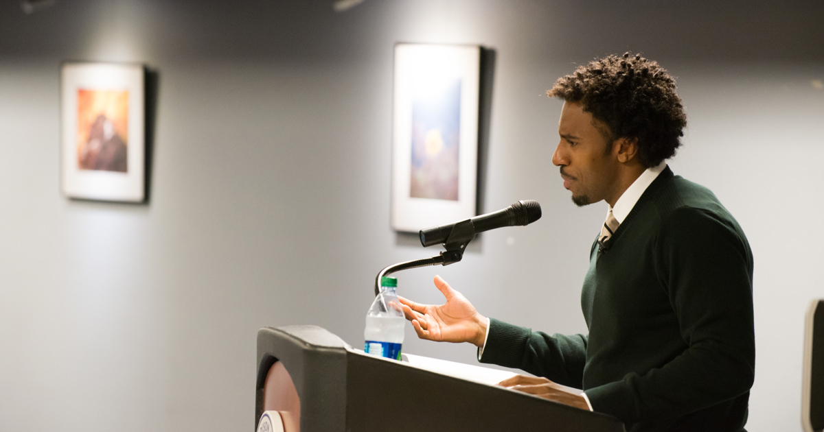 Kyle Dargan speaks at a podium