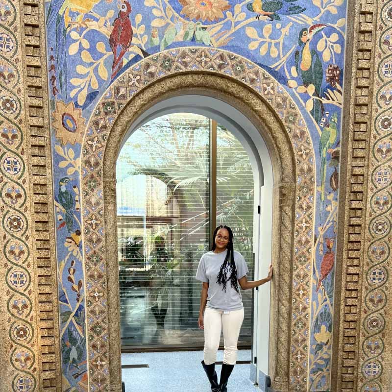 Mya under a decorated arch in the Smithsonian Bird House