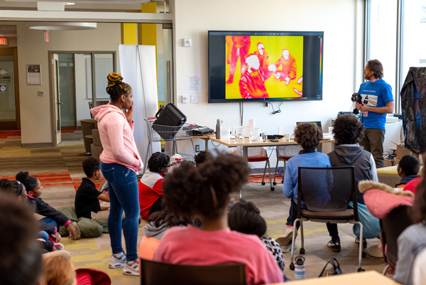 Visiting middle school students observe a demonstration on infrared light