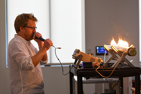 AU's Jonathan Newport demonstrates soundwaves with a device using flames