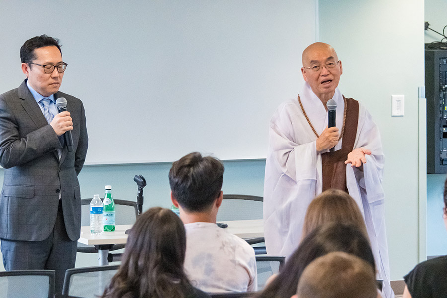 Venerable Pomnyun Sunim talks in front of an audience at AU