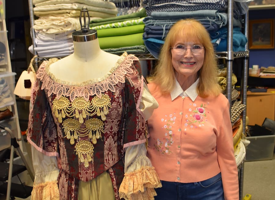Barbara Tucker Parker with costumes and supplies.