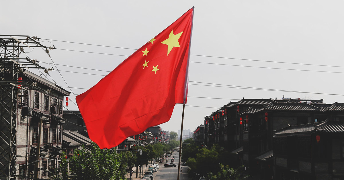 Chinese Flag flying above the street. Photo by: Ezreral Zhang