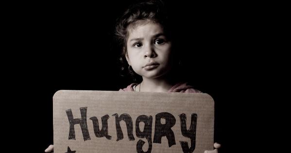 Child holding a sign that says Hungry