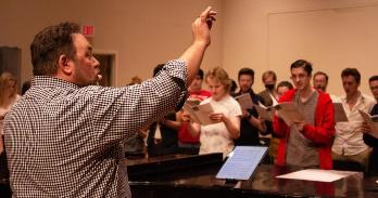 Professor Casey Cook conducting AU Chorus during rehearsal. Photo: Olivia Bloch