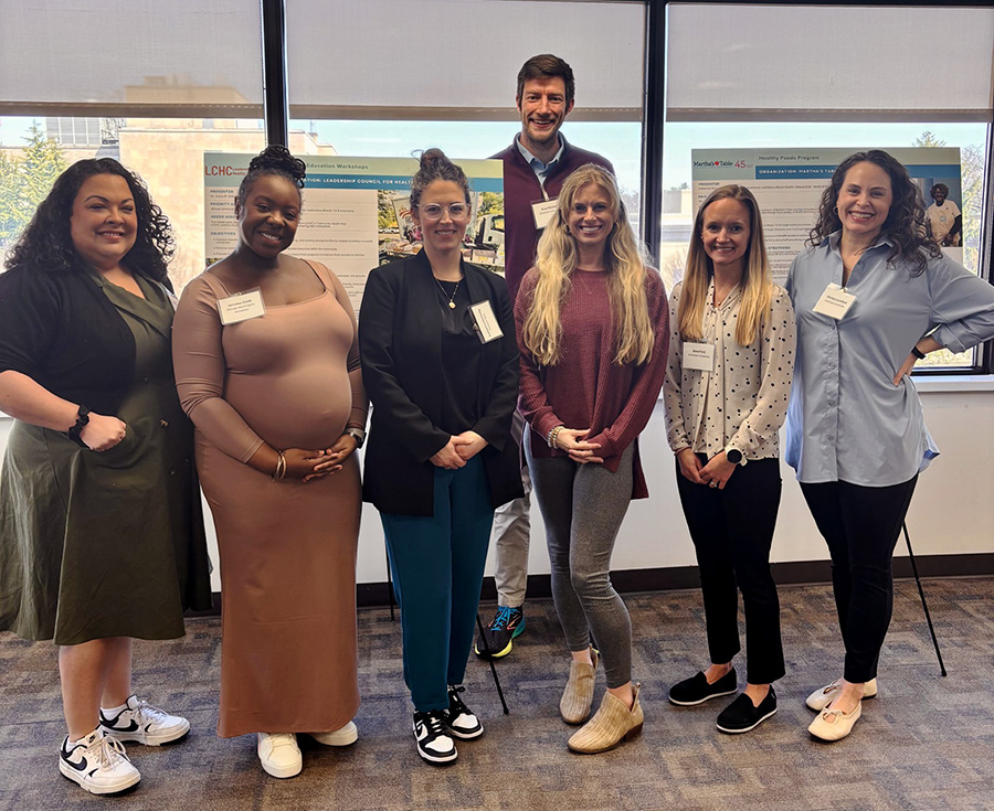 From left to right: Patrilie Hernandez, Jennifer Cook, Katherine Donnelly, Lindsey Van Wagner, Dara Ford, and Christy Lunsford, as well as Evan Reister (back)