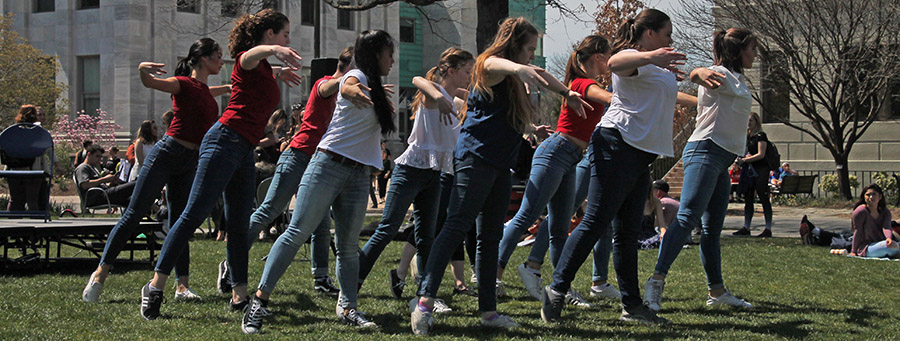 Dancers perform on the lawn in front of Mary Graydon Student Center