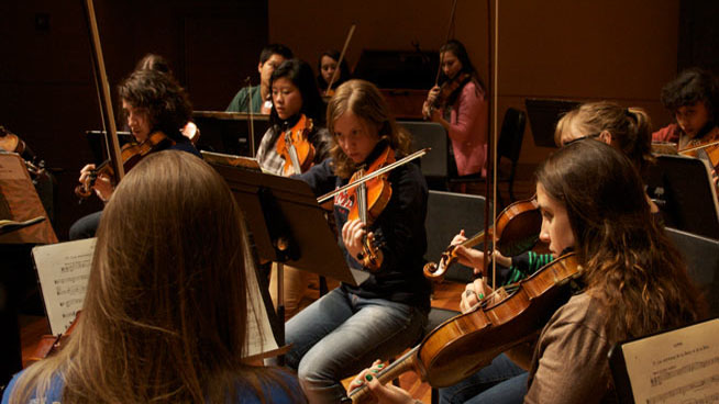 Students playing stringed instruments