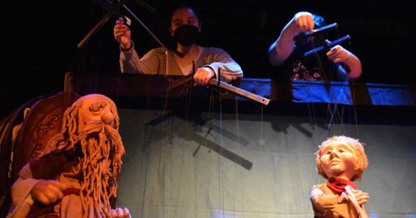Performers controlling puppets