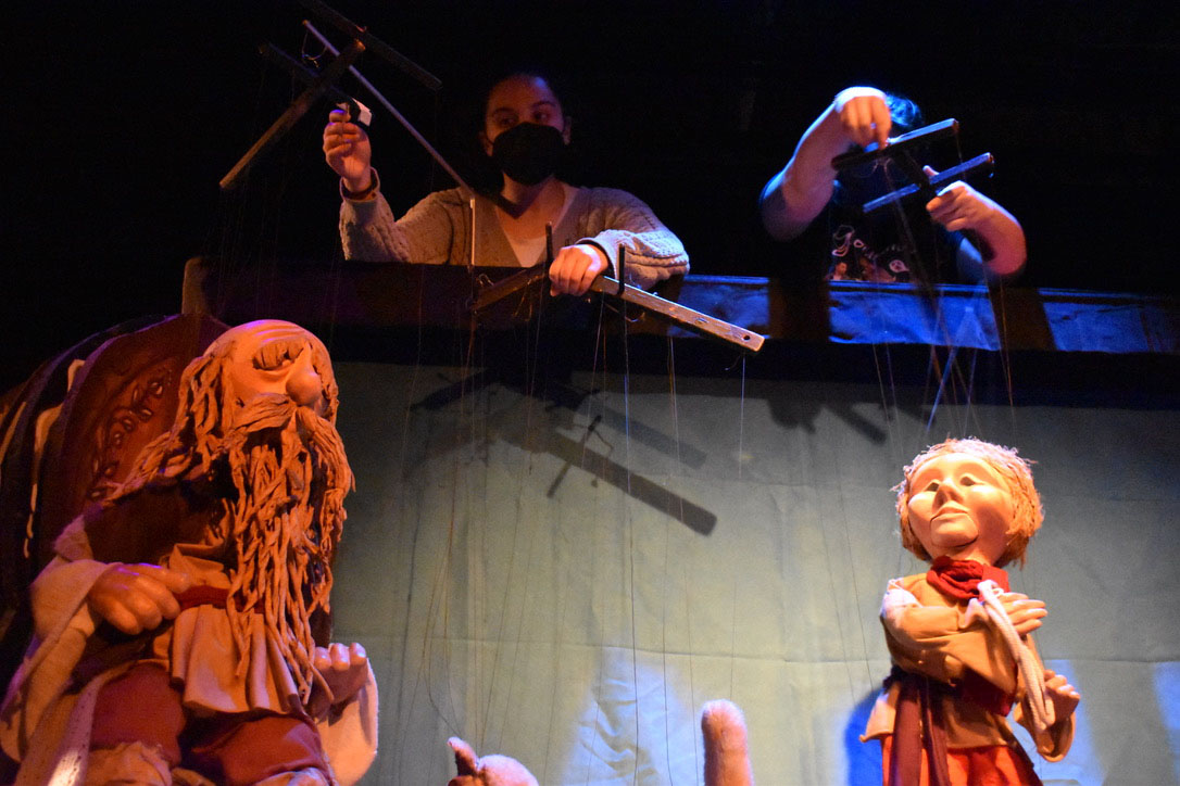 Performers controlling puppets