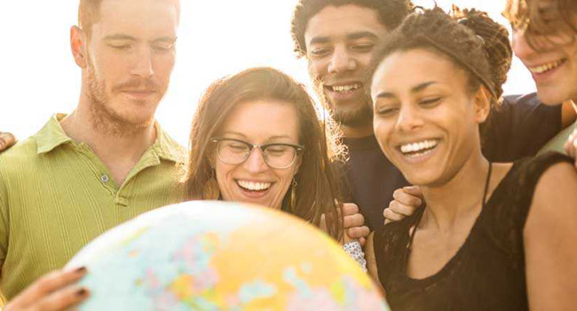 People looking at a globe