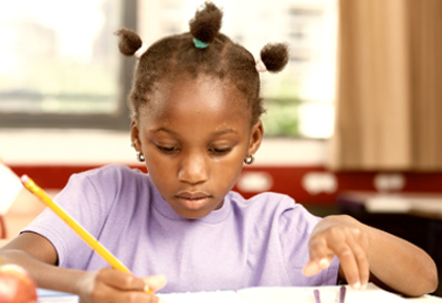 Child works on schoolwork at a desk