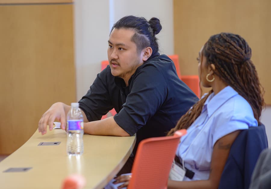 Two students joining post-presentation discussion.