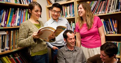 Students share a book.
