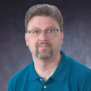 A headshot of Dr. Gregory Harry.