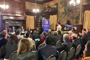 A group of people sitting in the library listening to a public panal