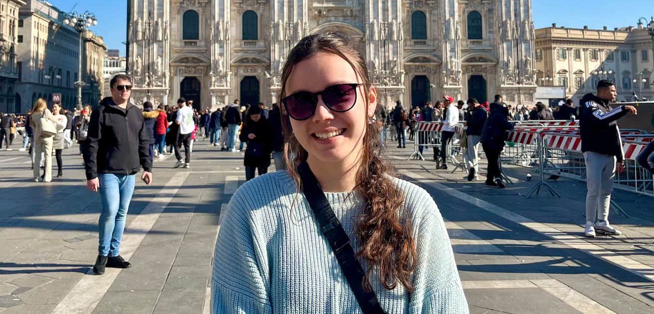 Hannah VanWagner, a student, in sunglasses with Milan Duomo in background.