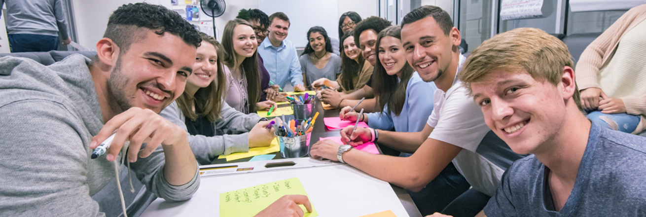 Students sit around a table