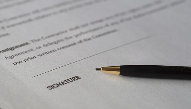 A contract page with a line for a signature