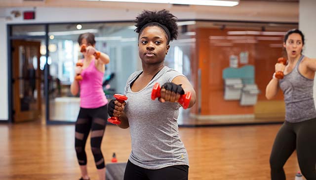 Woman with hand weights in exercise class