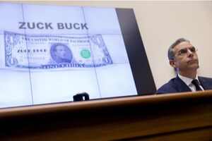 a projected display of paper money with Mark Zuckerberg's face on it and the words 