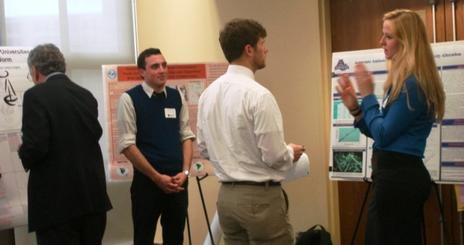 Students talking in front of the presentation posters