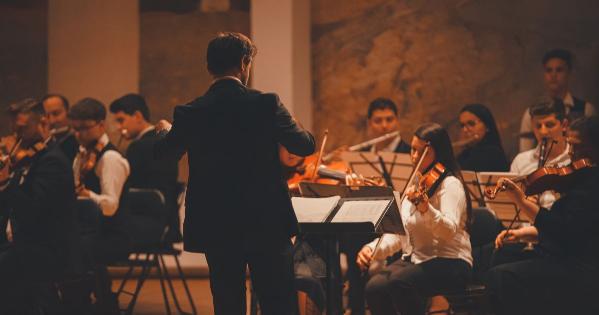 A conductor leading a symphony orchestra