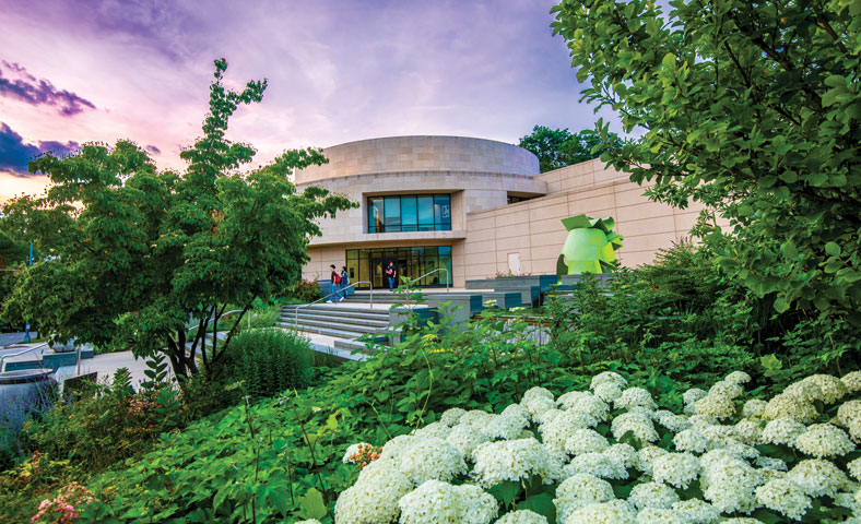 Katzen Arts Center surrounded by greenery at dusk