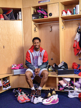 Colin Small, surrounded by sneakers in the AU locker room