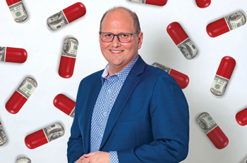 Kevin Hagan stands against a backdrop of pill capsules that are half red, half made of US currency bills
