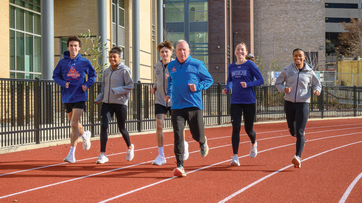 SPA lecturer Kevin Boyle runs the track with AU students