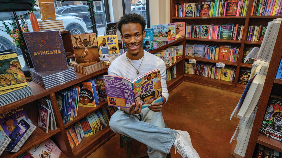 Sidney Keys III surrounded by children's books at Mahogany Books in Oxon Hill, Maryland