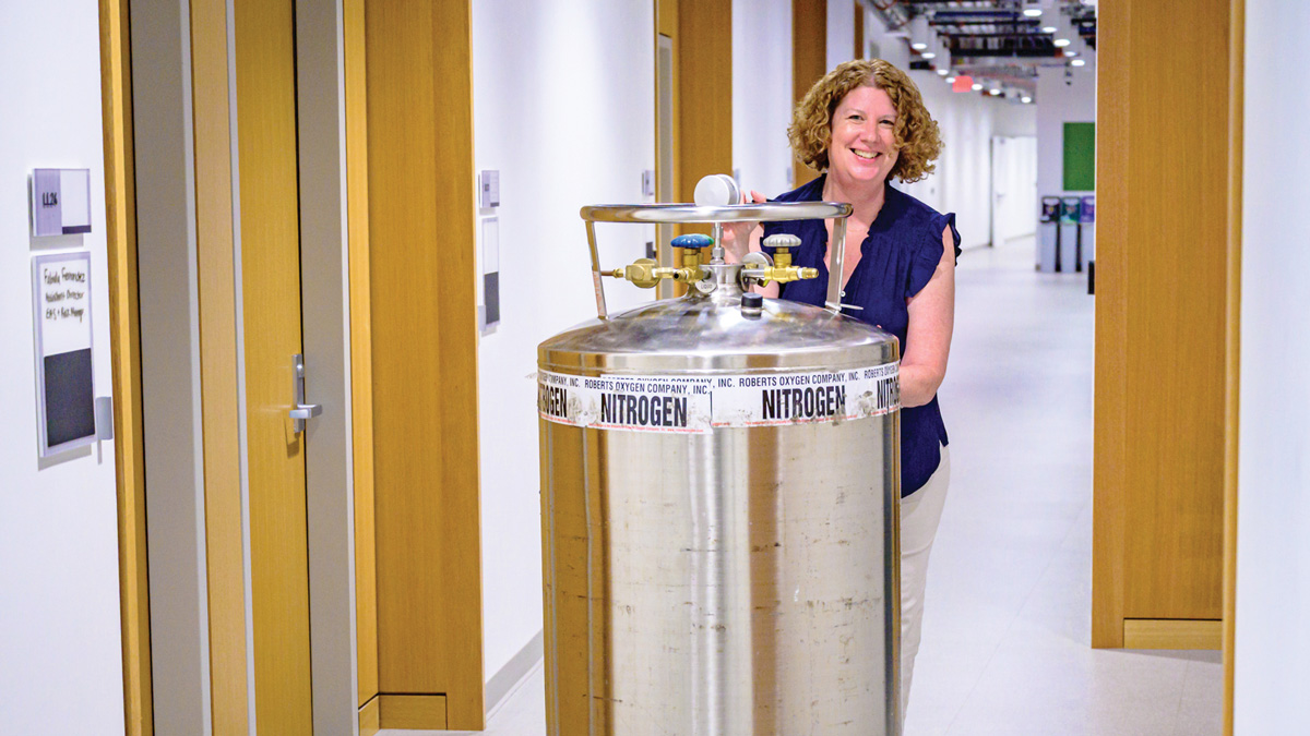 Bernadette Storey-Laubach pushes a nitrogen tank through the Hall of Science
