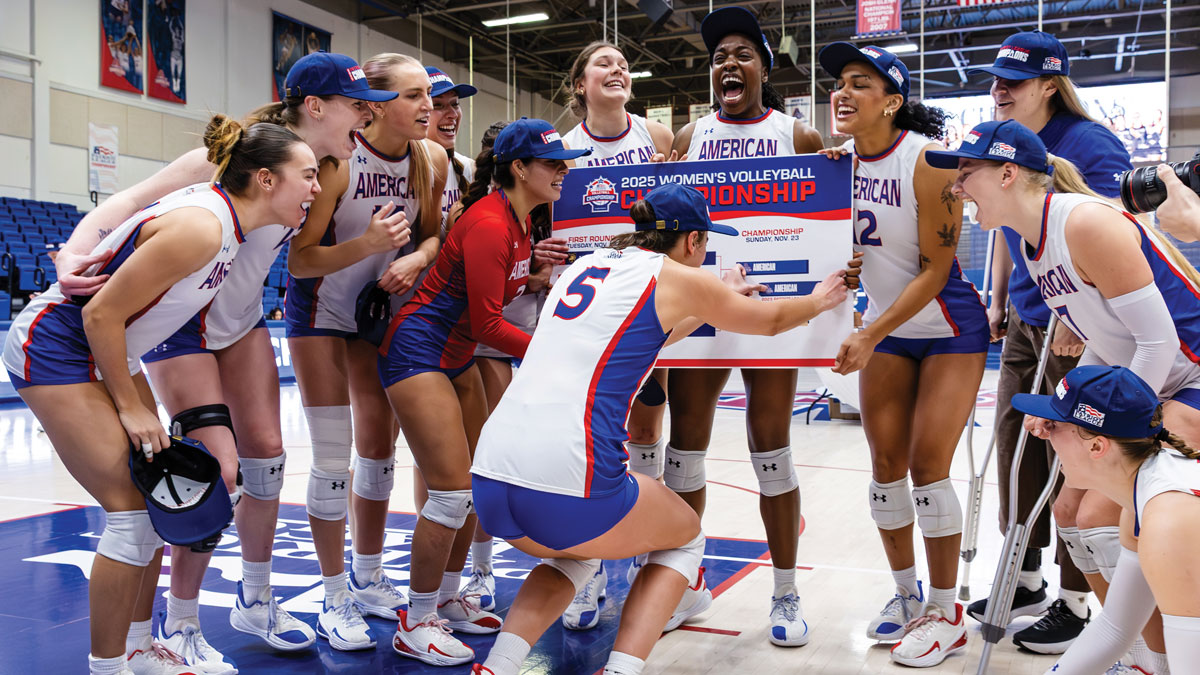 women's volleyball team celebrates in Bender Arena