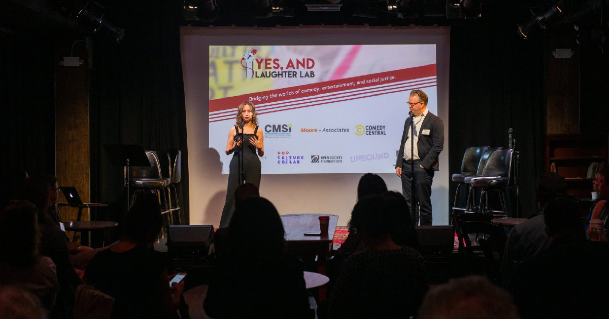 CMSI executive director Caty Borum Chattoo and Mik Moore, co-founders of the Yes, And … Laughter Lab introduce the first annual pitch day event in 2019.