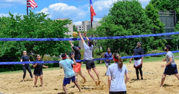 School of International SERVE-ice blocks a volley from Serves You Right. Photo by Jeff Watts. 