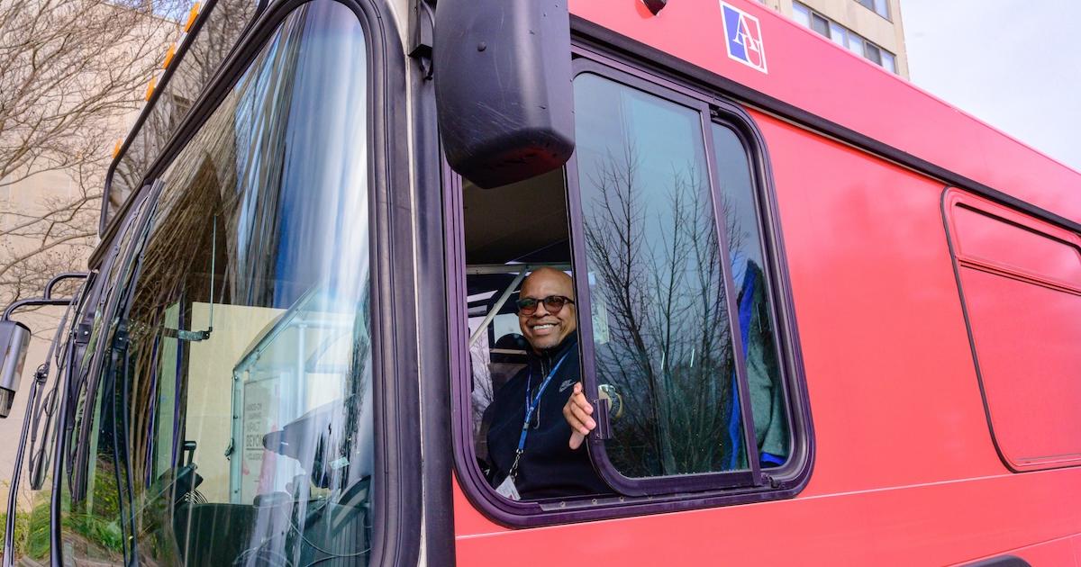 Don Tapp smiles from the window of his campus bus. Photo by Jeff Watts.