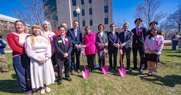 Dignitaries pose for a photo at a dedication for six new cherry blossom trees. Photo by Jeff Watts. 
