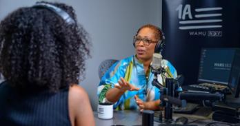 Jenn White engages with a guest in-studio. Photo by Jeff Watts.