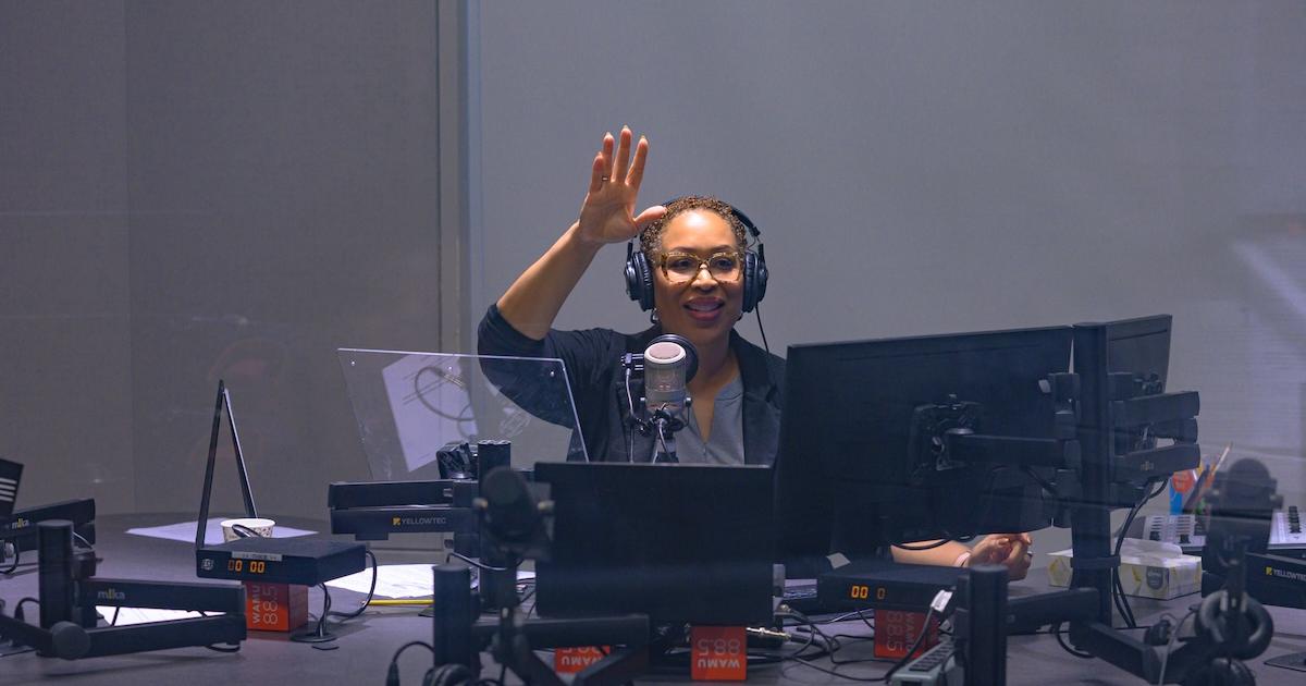 Jenn White waves from the studio. Photo by Jeff Watts.